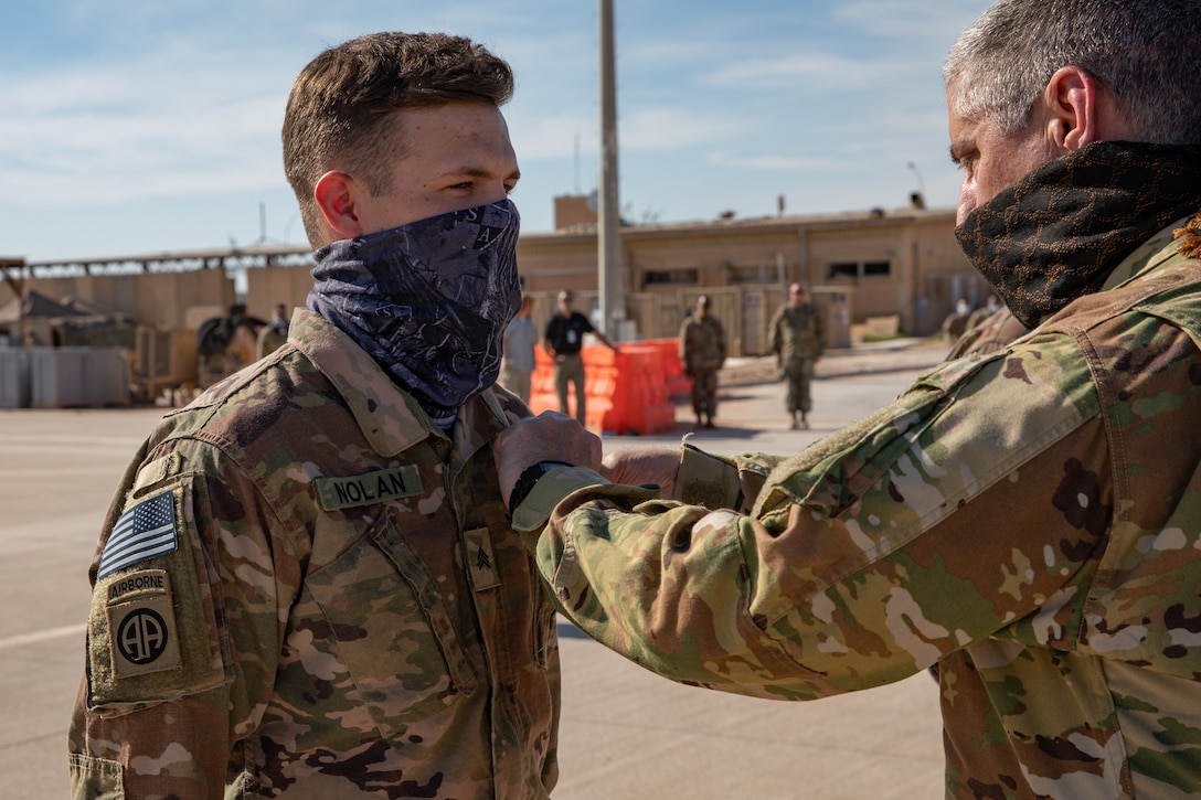 Sgt. Ryan Nolan is presented the Purple Heart medal by Col. Greg Fix, 34th Expeditionary Combat Aviation Brigade commander, May 3, 2020, for injuries sustained during A theater ballistic missile attacks at Al Asad Air Base, Iraq, Jan. 8, 2020.  Nolan Is a Flight Operations Non-commissioned officer with Delta Company, 82nd Aviation Regiment out of Fort Bragg, North Carolina. (U.S. Army photo by Sgt. Sydney Mariette)