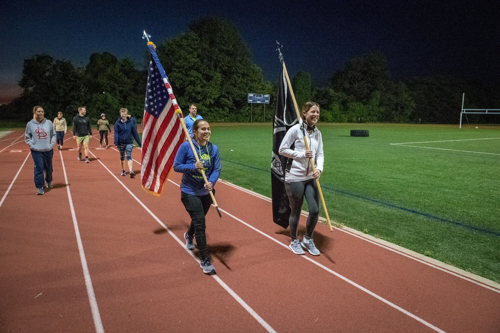 Citizen Airmen from the 932nd Airlift Wing honor U.S. military prisoners of war and those missing in action during the 11th Annual POW/MIA Vigil Run at the James Gym track, Scott Air Force Base, Illinois,  September 19, 2020.  The run was hosted by the Air Force Sergeants Association with the USO on site offering hot beverages and food.  This year's event had the extra COVID-19 precautions with maintaining smaller groups safely spaced while moving the flags around the track. (U.S. Air Force photo by Master Sgt. Christopher Parr)