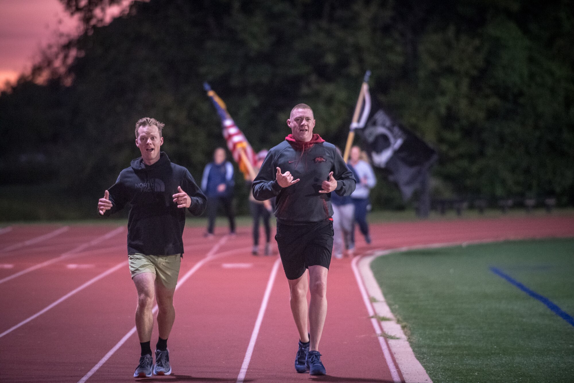 Citizen Airmen from the 932nd Airlift Wing honor U.S. military prisoners of war and those missing in action during the 11th Annual POW/MIA Vigil Run at the James Gym track, Scott Air Force Base, Illinois,  September 19, 2020.  The run was hosted by the Air Force Sergeants Association with the USO on site offering hot beverages and food.  This year's event had the extra COVID-19 precautions with maintaining smaller groups safely spaced while moving the flags around the track. (U.S. Air Force photo by Master Sgt. Christopher Parr)