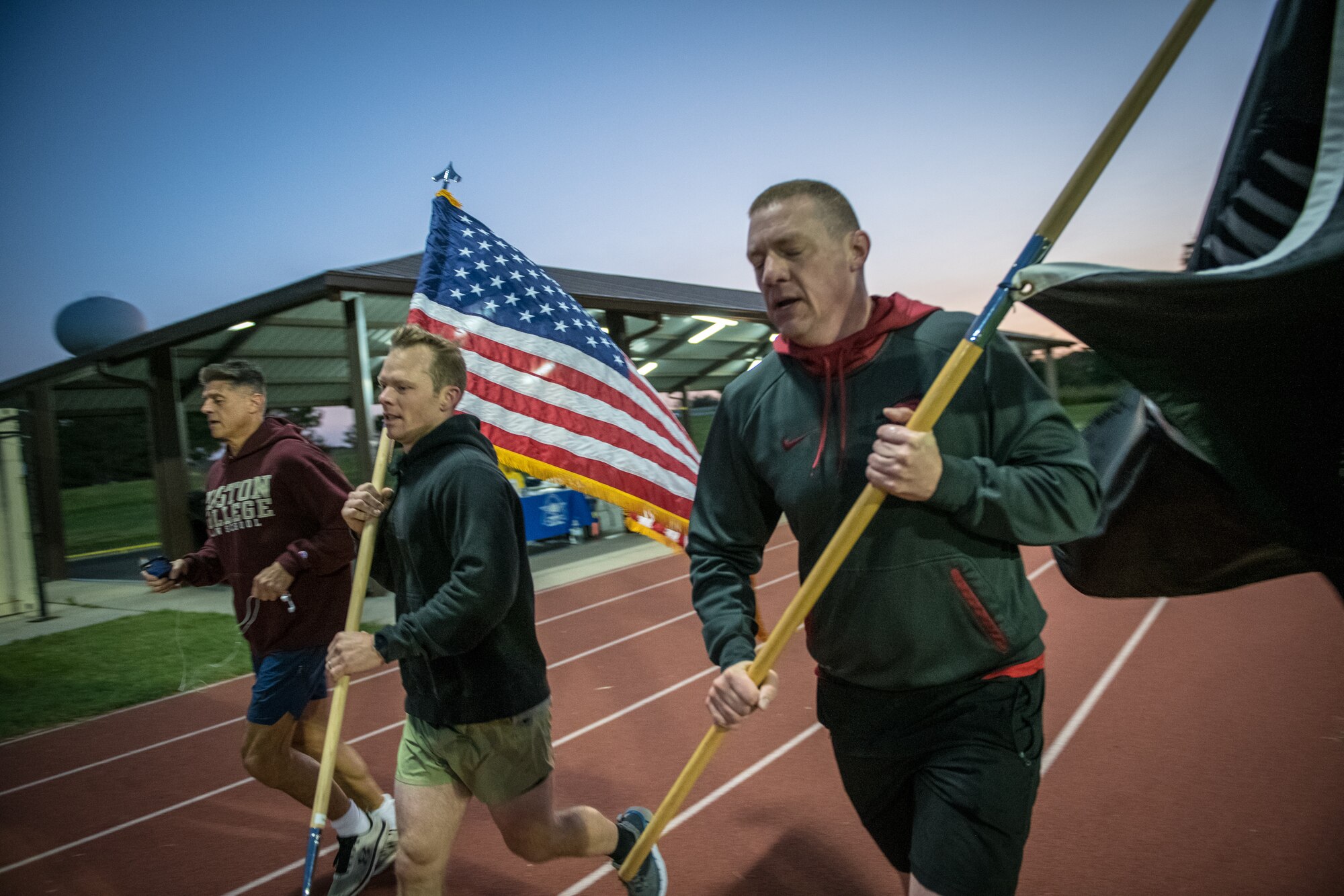Citizen Airmen from the 932nd Airlift Wing honor U.S. military prisoners of war and those missing in action during the 11th Annual POW/MIA Vigil Run at the James Gym track, Scott Air Force Base, Illinois,  September 19, 2020.  The run was hosted by the Air Force Sergeants Association with the USO on site offering hot beverages and food.  This year's event had the extra COVID-19 precautions with maintaining smaller groups safely spaced while moving the flags around the track. (U.S. Air Force photo by Master Sgt. Christopher Parr)