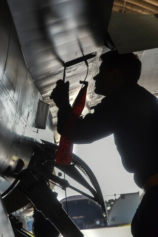 Crew chiefs conduct pre-flight inspections on an F-16 Fighting Falcon