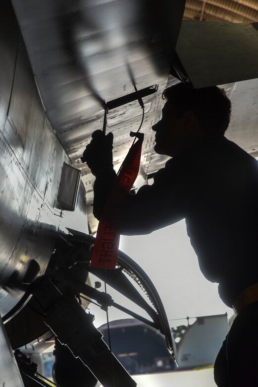 Crew chiefs conduct pre-flight inspections on an F-16 Fighting Falcon