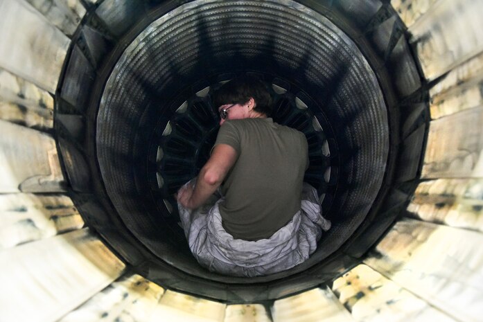 Crew chiefs conduct pre-flight inspections on an F-16 Fighting Falcon