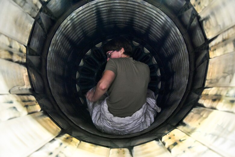 Crew chiefs conduct pre-flight inspections on an F-16 Fighting Falcon