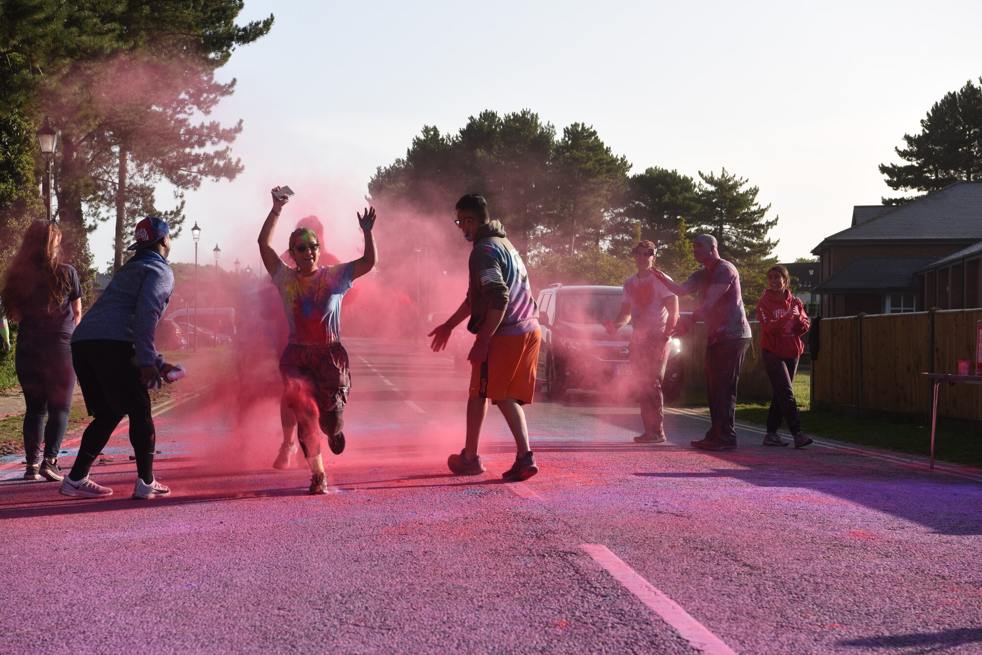 A Team Mildenhall Airman runs through a cloud of dye during the 5K Color Run for Equality at Royal Air Force Mildenhall, England, Sept. 18, 2020.