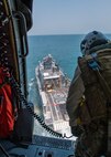 Naval Air Crewman 2nd Class Seth Douglas, assigned to Helicopter Sea Combat Squadron (HSC) 26, prepares to hoist explosive ordnance disposal technicians, assigned to Commander, Task Force (CTF) 56, from a Mark VI patrol boat into a MH-60S Sea Hawk helicopter during hoist training operations in the Arabian Gulf, Sept. 3. CTF 56 and HSC-26 are deployed to the U.S. 5th Fleet area of operations and conduct mine warfare operations in support of naval operations to ensure maritime stability and security in the Central Region, connecting the Mediterranean and Pacific through the Western Indian Ocean and three strategic chokepoints to the free flow of global commerce.