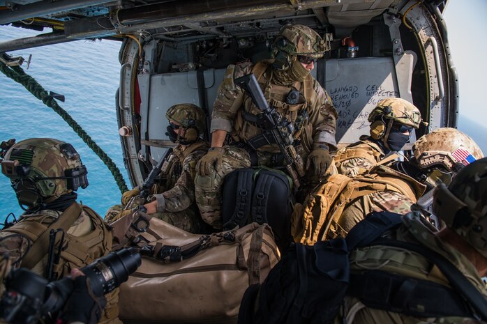 Explosive ordnance disposal technicians, assigned to Commander, Task Force (CTF) 56, prepare to fast-rope from a MH-60S Sea Hawk helicopter, attached to Helicopter Sea Combat Squadron (HSC) 26, during a fast-rope training evolution in the Arabian Gulf, Sept. 3. CTF 56 and HSC-26 are deployed to the U.S. 5th Fleet area of operations and conduct mine warfare operations in support of naval operations to ensure maritime stability and security in the Central Region, connecting the Mediterranean and Pacific through the Western Indian Ocean and three strategic chokepoints to the free flow of global commerce.