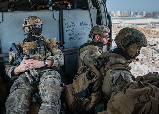 Explosive ordnance disposal technicians, assigned to Commander, Task Force (CTF) 56, ride in a MH-60S Sea Hawk helicopter, attached to Helicopter Sea Combat Squadron (HSC) 26, after conducting fast-rope training in the Arabian Gulf, Sept. 3. CTF 56 and HSC-26 are deployed to the U.S. 5th Fleet area of operations and conduct mine warfare operations in support of naval operations to ensure maritime stability and security in the Central Region, connecting the Mediterranean and Pacific through the Western Indian Ocean and three strategic chokepoints to the free flow of global commerce.