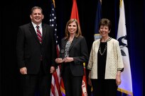 James F. Geurts, Assistant Secretary of the Navy for Research, Development & Acquisition (ASN (RD&A)), joins Dr. Delores M. Etter, former (ASN (RD&A)) and current professor emeritus, Southern Methodist University, as they present the 2017 Dr. Delores M. Etter Top Scientists and Engineers Award for Individual Engineers to Dr. Linda M. Thomas, Naval Research Laboratory, during a ceremony at the Pentagon. (U.S. Navy photo by John F. Williams/Released)