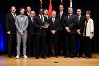 James F. Geurts, Assistant Secretary of the Navy for Research, Development & Acquisition (ASN (RD&A)), joins Dr. Delores M. Etter, former (ASN (RD&A)) and current professor emeritus, Southern Methodist University, as they present the 2017 Dr. Delores M. Etter Top Scientists and Engineers Group Award to the Innovative Naval Prototype Nemesis Engineering Leadership team, during a ceremony at the Pentagon. (U.S. Navy photo by John F. Williams/Released)