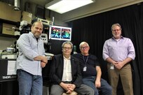 Pictured left to right are NRL researchers Drs. Igor Medintz, Alexander Efros, Alan Huston, and James Delehanty in front of a customized fluorescence microscope equipped for microinjection of quantum dots and other nanoparticles into living cells.