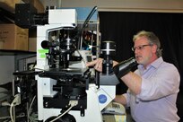 Dr. James Delehanty demonstrates the use of the cell microinjection system.
