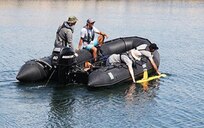 Divers from Naval Undersea Warfare Center Division Newport's Engineering and Diving Support Unit recover an unmanned autonomous underwater vehicle during ANTX HMI 2018. The event, which included industry participants and U.S. Navy leaders, was held at Narragansett Bay Test Facility, Aug. 29-31, 2018. ANTX is an annual event designed to test new technology with academic, industry and Navy participants. The theme of this year's ANTX is "Human Machine Interaction. Photo by Public Affairs Office.
