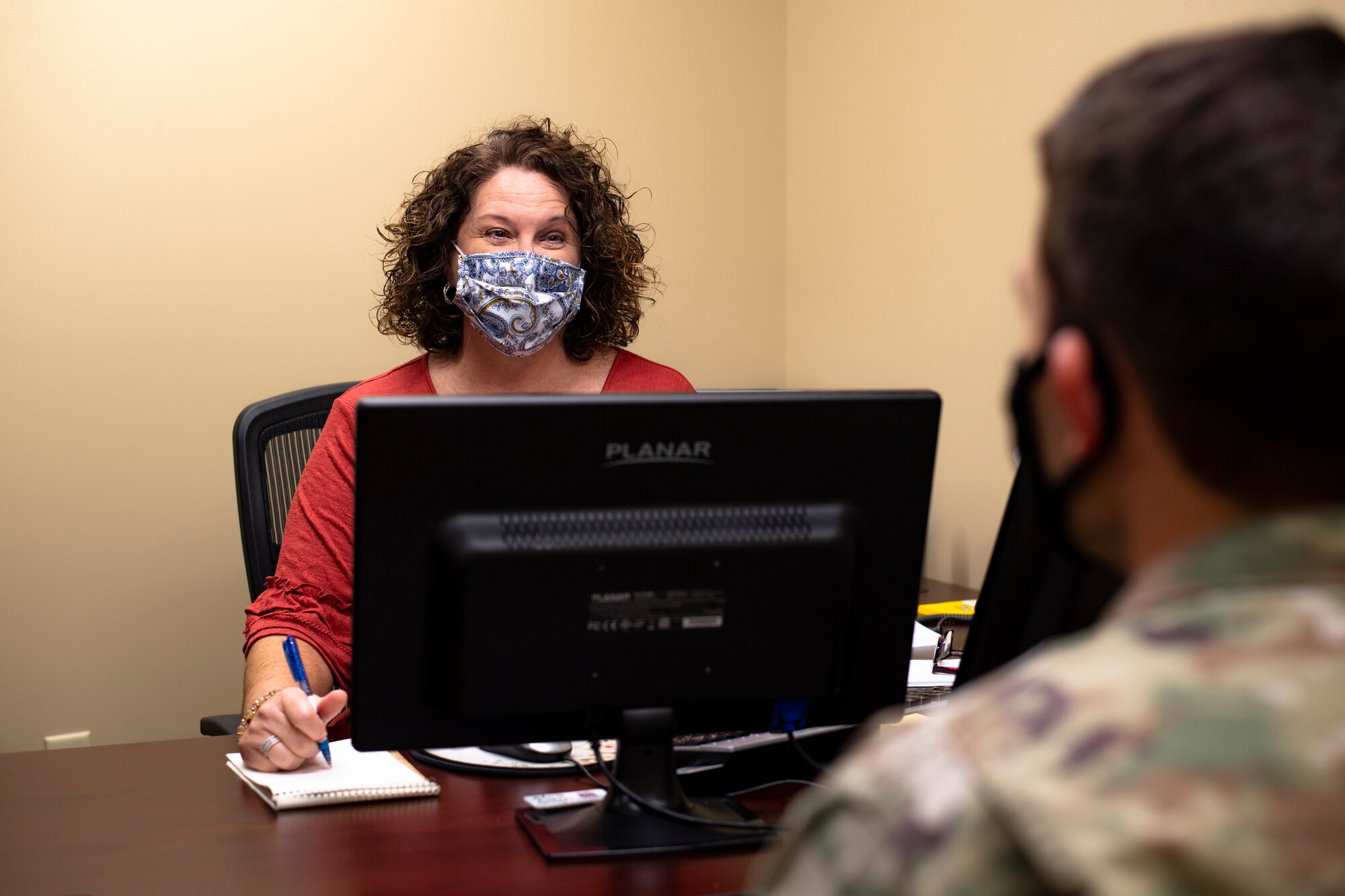 A photo of the resident advocate speaking with a client
