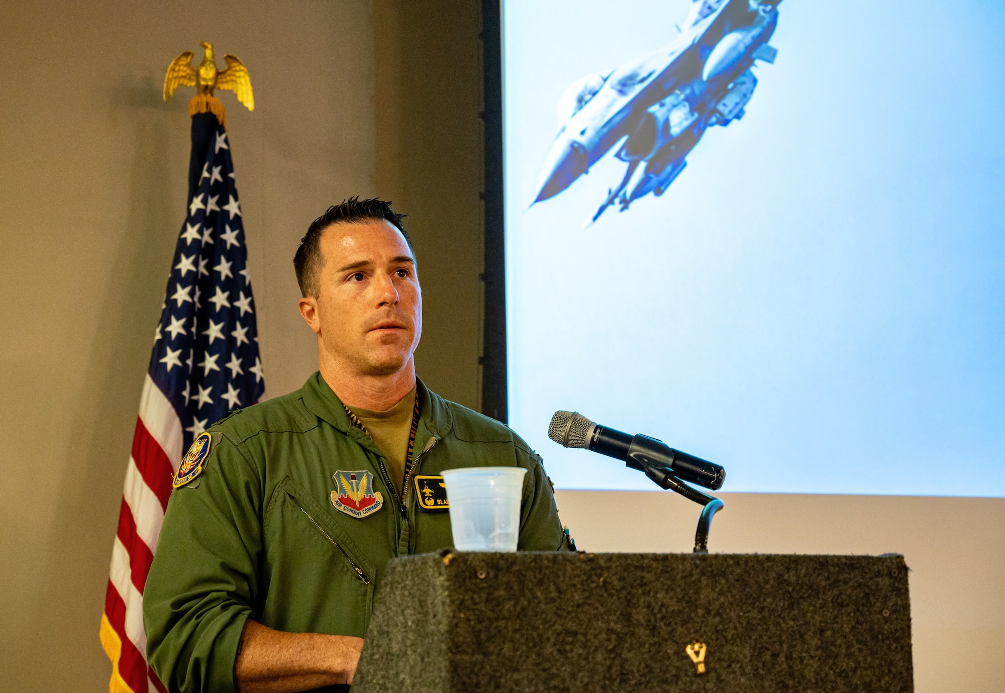 A photo of an Airman at a podium.