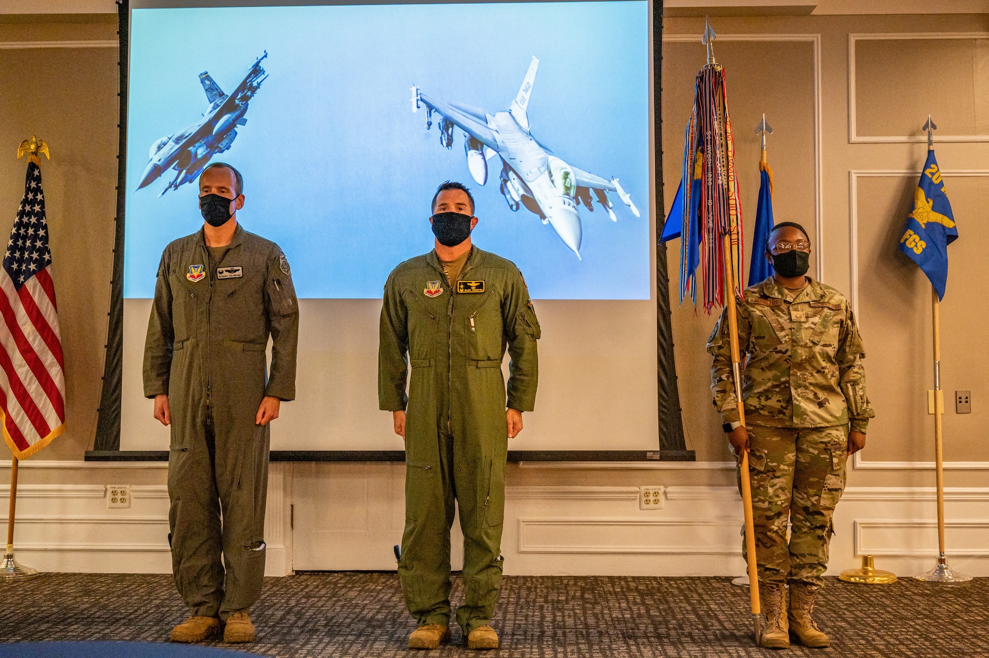 A photo of three Airmen standing at attention.