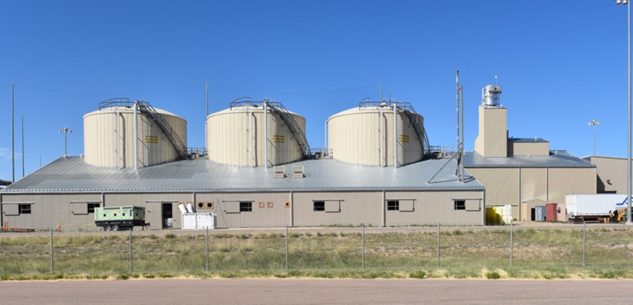 A building is situated behind a fence.