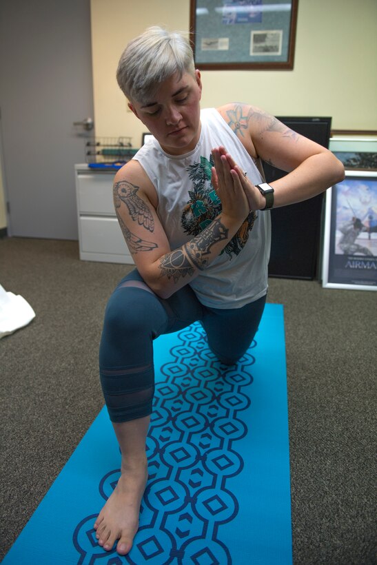 Justyne Strohmeyer, wing historian with the 911th Airlift Wing, demonstrates the warrior pose at the Pittsburgh International Airport Air Reserve Station, Pennsylvania, Sept. 17, 2020.