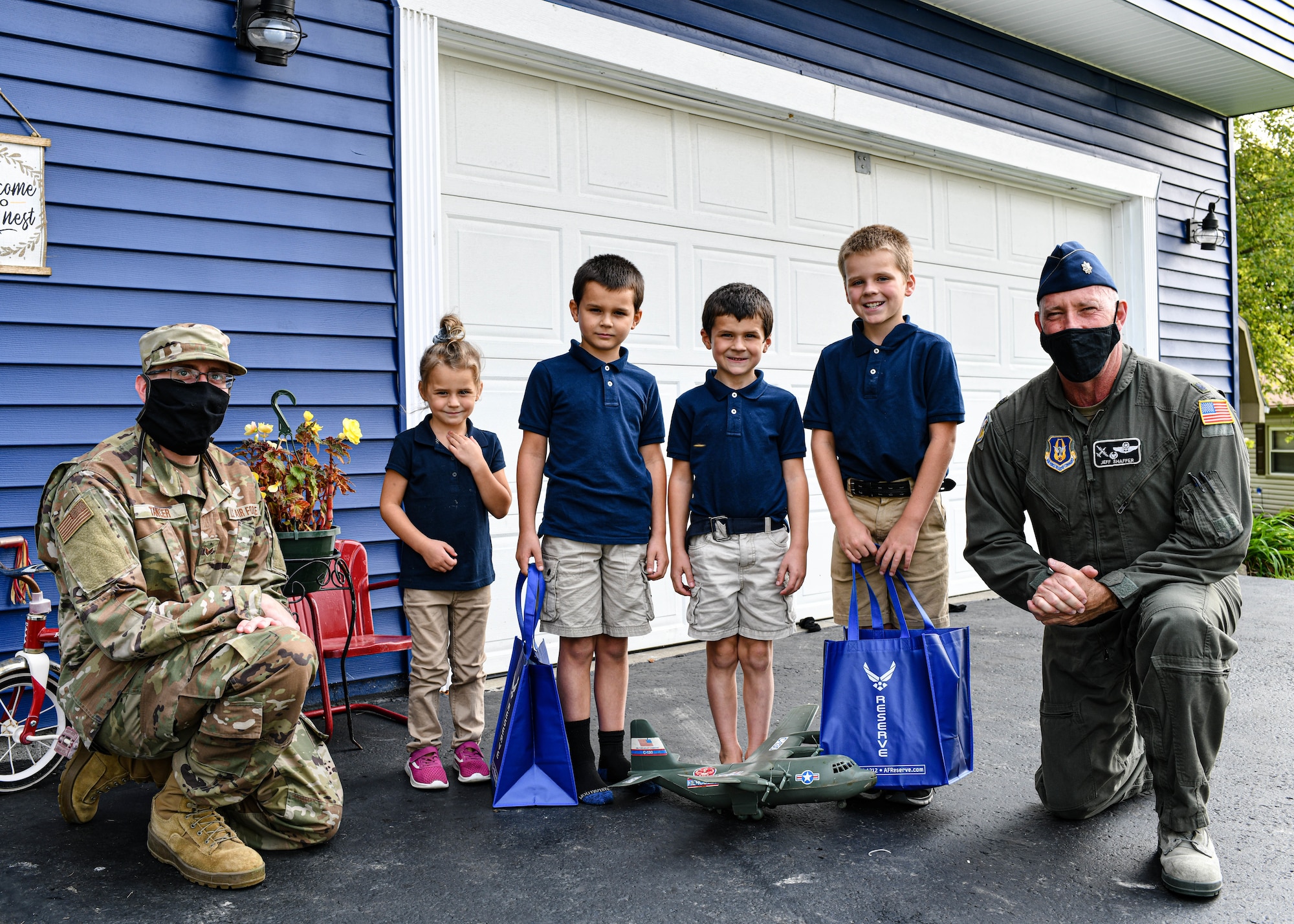 910th Operations Group Commander Lt. Col. Jeff Shaffer delivered Air Force Reserve swag to the McCloskey family in recognition of their son's love for C-130 aircraft and support of the unit.