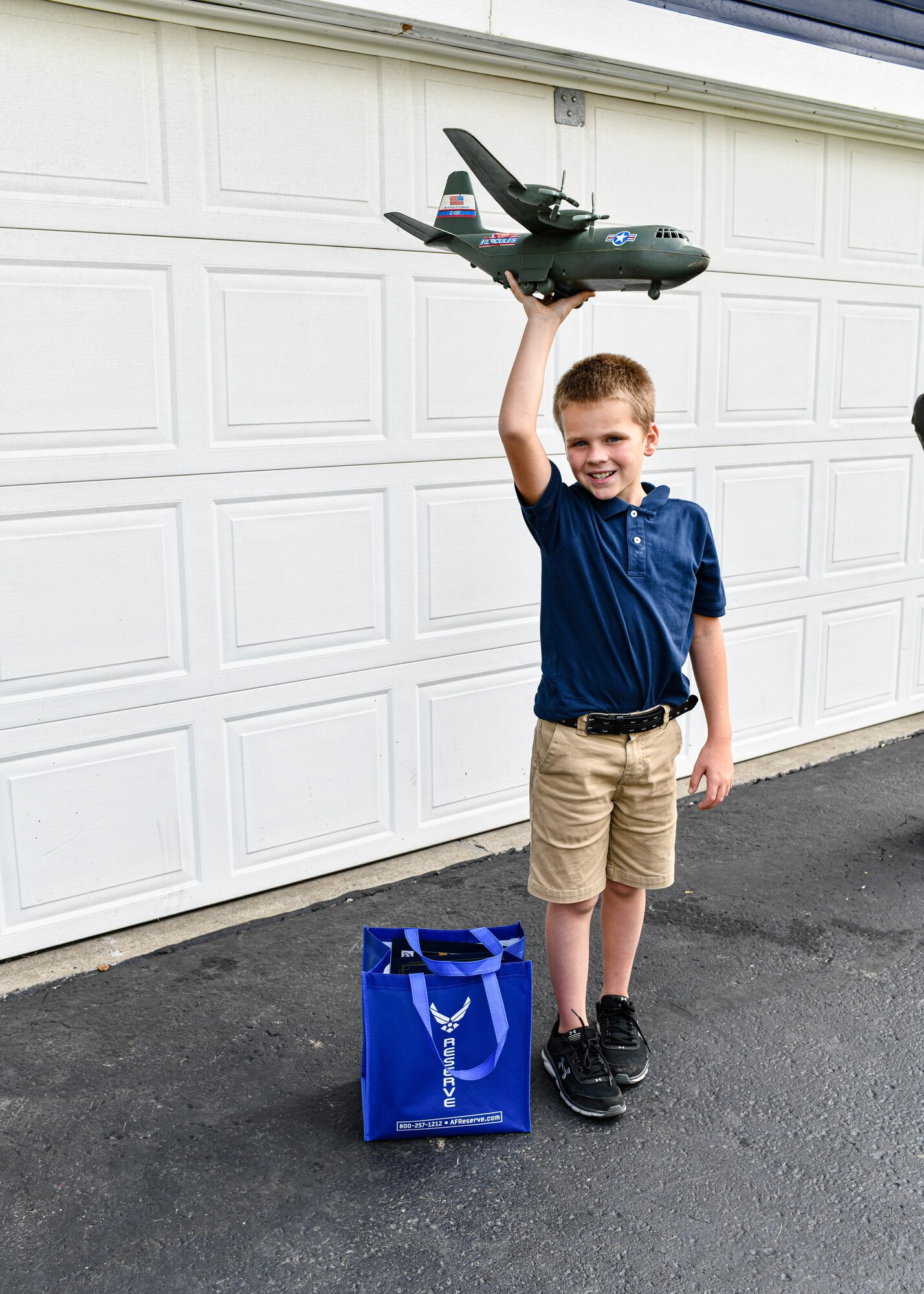910th Operations Group Commander Lt. Col. Jeff Shaffer delivered Air Force Reserve swag to the McCloskey family in recognition of their son's love for C-130 aircraft and support of the unit.