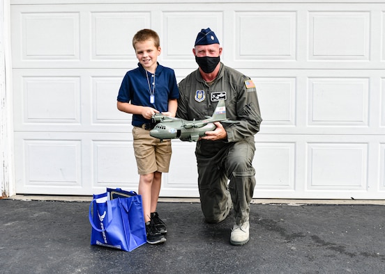 910th Operations Group Commander Lt. Col. Jeff Shaffer delivered Air Force Reserve swag to the McCloskey family in recognition of their son's love for C-130 aircraft and support of the unit.