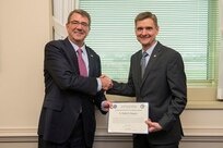 ecretary of Defense, Ash Carter (left), honors Dr. Bradley Ringeisen with the prestigious ‘Laboratory Scientist of the Quarter’ award for the fourth quarter of fiscal year 2015. Head of the Bioenergy and Biofabrication Section at the U.S. Naval Research Laboratory (NRL), Ringeisen receives the award for extraordinary service to the Department of Defense (DoD) for distinguished accomplishments in the development and expansion of the applications of three-dimensional (3D) bioprinting using the Navy’s patented biological laser printer, or BioLP.