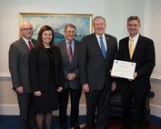 At the 2015 Department of Defense (DoD) Laboratory Scientist of the Quarter award ceremony honoring Dr. Bradley Ringeisen (right), head of the Bioenergy and Biofabrication Section at the U.S. Naval Research Laboratory (NRL), are (l-r): Mr. Stephen P. Welby, Acting Principal Deputy Assistant Secretary of Defense for Research and Engineering Performing the Duties of the Assistant Secretary of Defense for Research and Engineering; Dr. Melissa L. Flagg, Deputy Assistant Secretary of Defense for Research; Dr. John Montgomery, NRL Director of Research; and Mr. Frank Kendall, Under Secretary of Defense for Acquisition, Technology and Logistics.