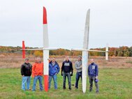 The U.S. Naval Research Laboratory (NRL) and Pennsylvania State University combined efforts to demonstrate sustained unmanned, powerless flight of two UAV sailplanes during testing of the solar-soaring and cooperative soaring algorithm-based concepts. The test flights occurred during the weeks of September 28 and October 26, 2015, successfully demonstrating proof-of-concept of in-flight collaborative soaring and swarming capabilities of non-powered UAVs. Pictured (left to right) are NRL team members Chris Bovais, Dan Edwards, and Trent Young and PSU team members Jack Langelaan, Nate Depenbusch, and John Bird.
