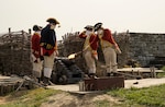 Re-enactors wearing 18th century uniforms demonstrate the firing of a cannon at Fort Ticonderoga in New York Sept. 16, 2020, for members of the New York Army National Guard. The visit was part of the Company Commander and First Sergeant Pre-Command Course of instruction Sept. 14-18. Three dozen Soldiers toured the historic battlefield of the American Revolution and French and Indian War to discover leadership lessons to prepare for their upcoming command tours.