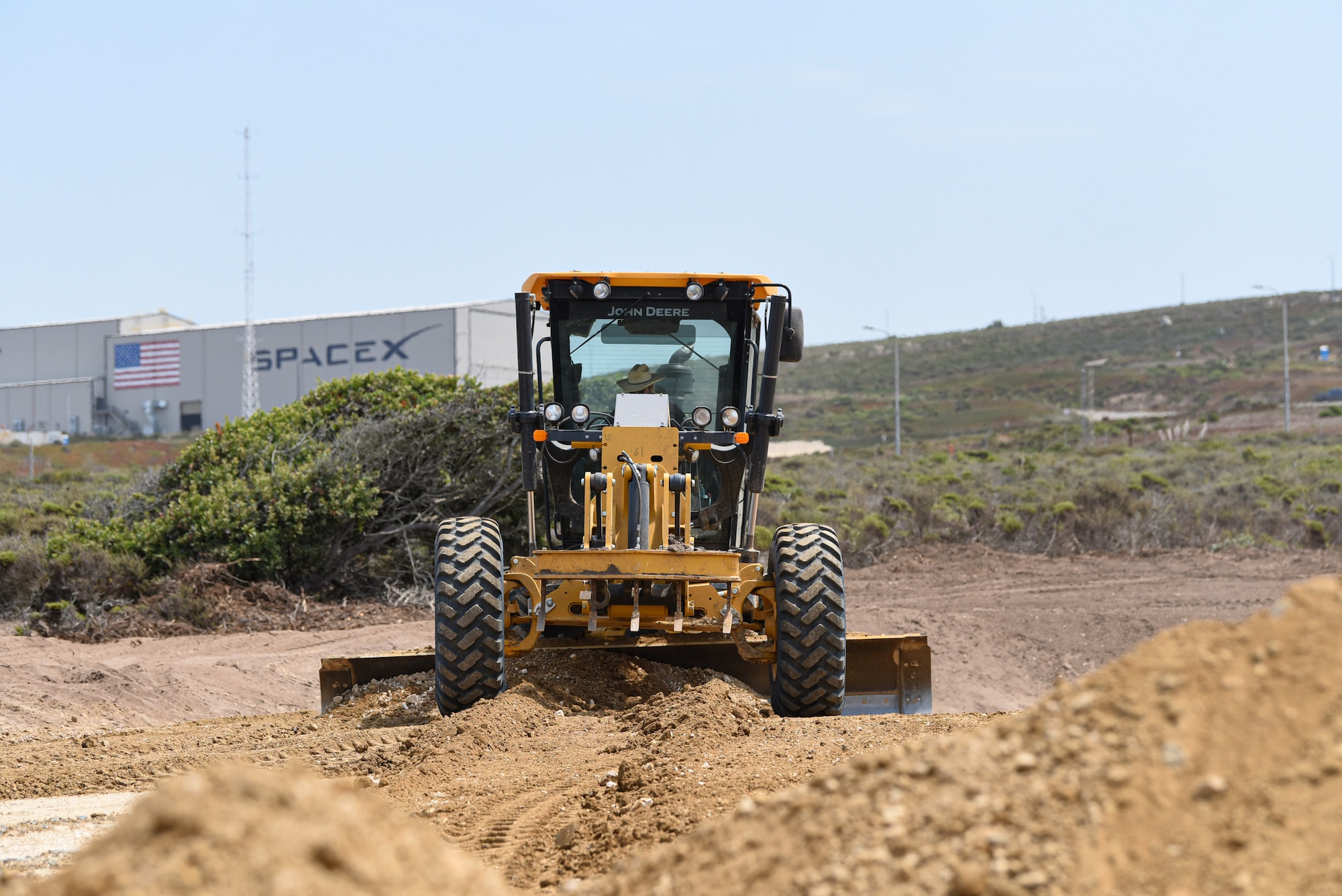 Alex Escalante, 30th Civil Engineer Squadron heavy equipment operator, plows through mounds of dirt to create a gaseous nitrogen pad Aug. 18, 2020, at Vandenberg Air Force Base, Calif. The construction of the pad increases the flexibility of range infrastructure by providing a contingency location for nitrogen support when the nitrogen plant is unavailable and eliminates a single point of failure. (U.S. Air Force photo by Senior Airman Hanah Abercrombie)