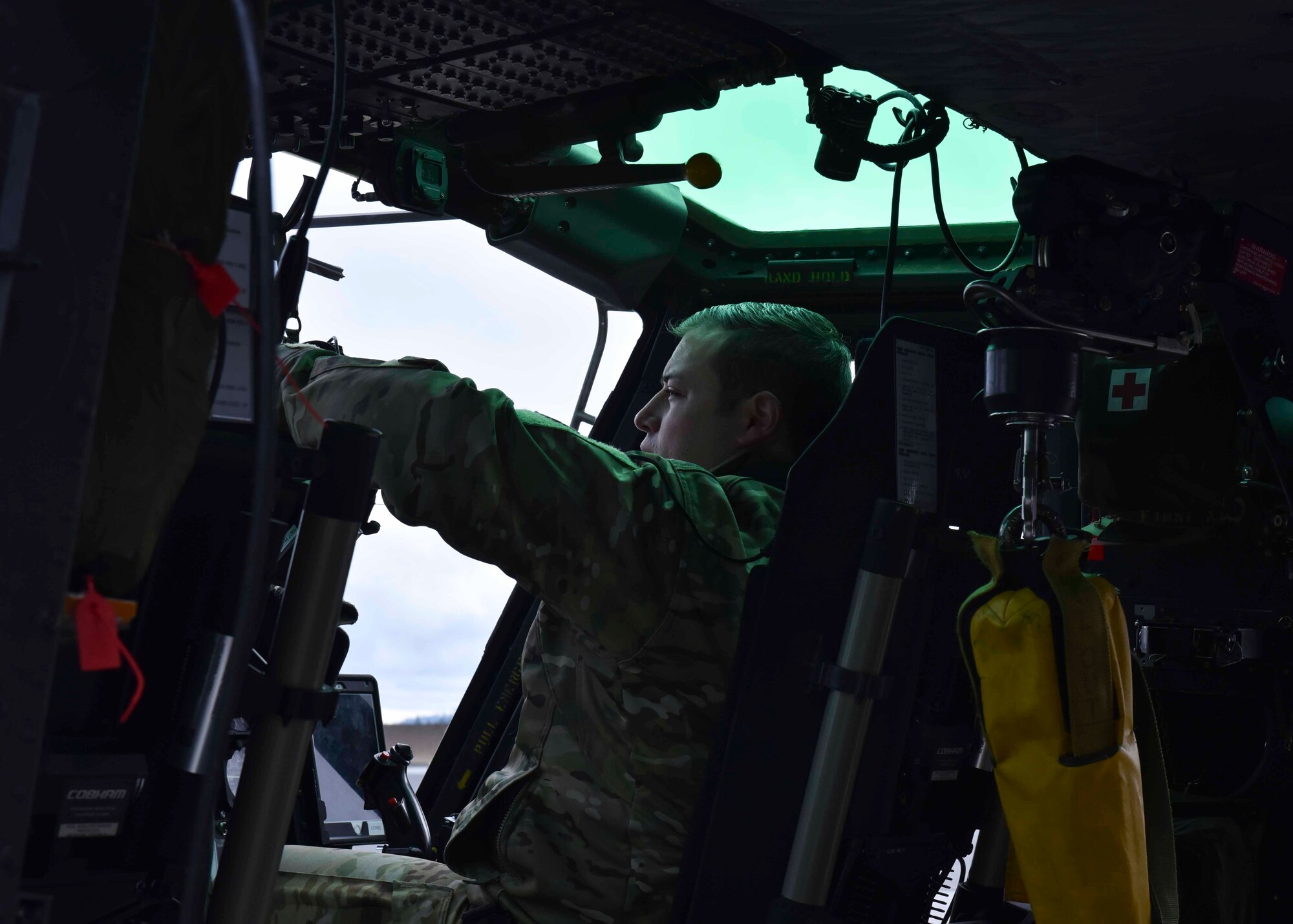 U.S. Air Force Capt. Joel Lewis, 36th Rescue Squadron executive officer, prepares a Bell UH-1N Iroquois helicopter for flight at Fairchild Air Force Base, Washington, Jan. 30, 2020. Lewis and two other Airmen from the 36th RQS flew over the Survival, Evasion, Resistance and Escape school to hoist 40 SERE students. (U.S. Air Force by Airman 1st Class Kiaundra Miller)