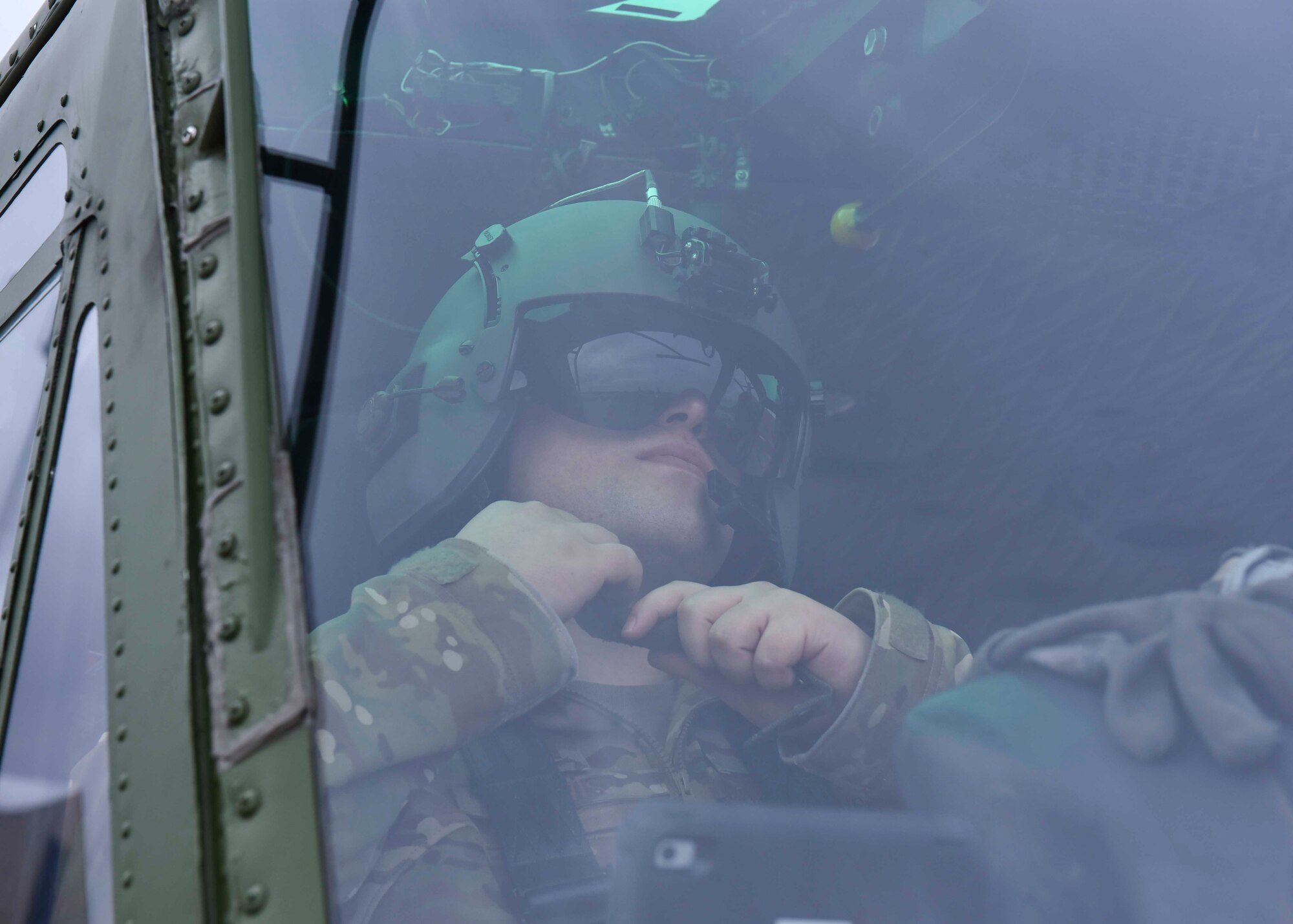 U.S. Air Force Capt. Joel Lewis, 36th Rescue Squadron executive officer, secures his helmet prior to takeoff at Fairchild Air force Base, Washington, Jan. 30, 2020. The 36th RQS is unique to the Air Force because it provides training to several different career fields to include the Survival, Evasion, Resistance and Escape school, helicopter pilots, combat rescue officers, special tactics Airmen, and the Portland Air National Guard. (U.S. Air Force photo by Airman 1st Class Kiaundra Miller)