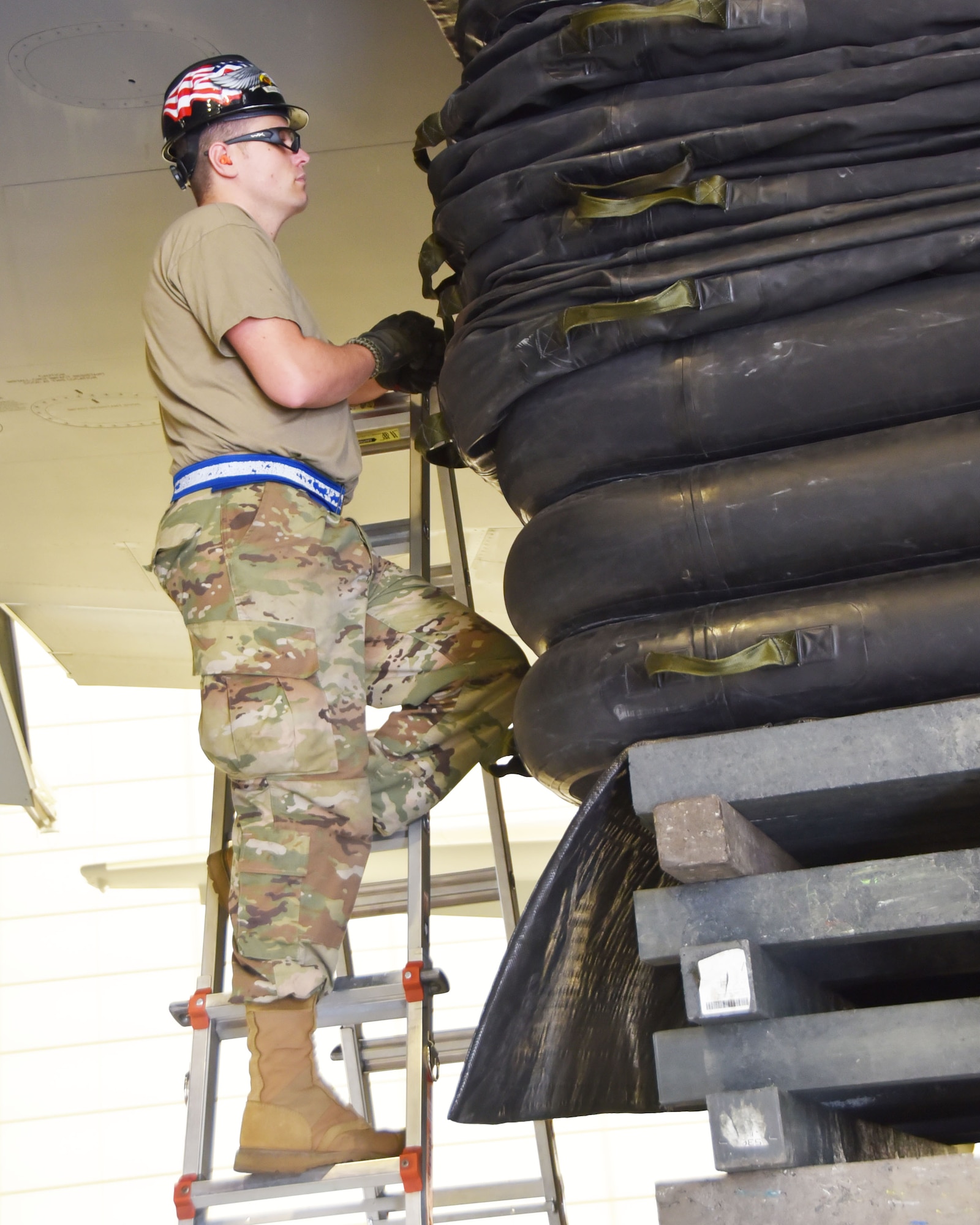 Tech. Sgt. Tommy James, 22nd Maintenance Squadron KC-46A Pegasus Repair and Reclamation craftsman, and Crashed, Damaged or Disabled Aircraft Recovery NCOIC, checks the lift bag for proper inflation and stability Sept. 17, 2020, at McConnell Air Force Base, Kansas.  The training was part of a week-long CDDAR exercise that involved 15 members from the 22nd and 931st Maintenance Squadrons.  The lifting bags are placed on top of a makeshift platfrom of railroad ties and plywood sheets, and under the wing of damaged aircraft secure it prior to beginning maintenance repairs