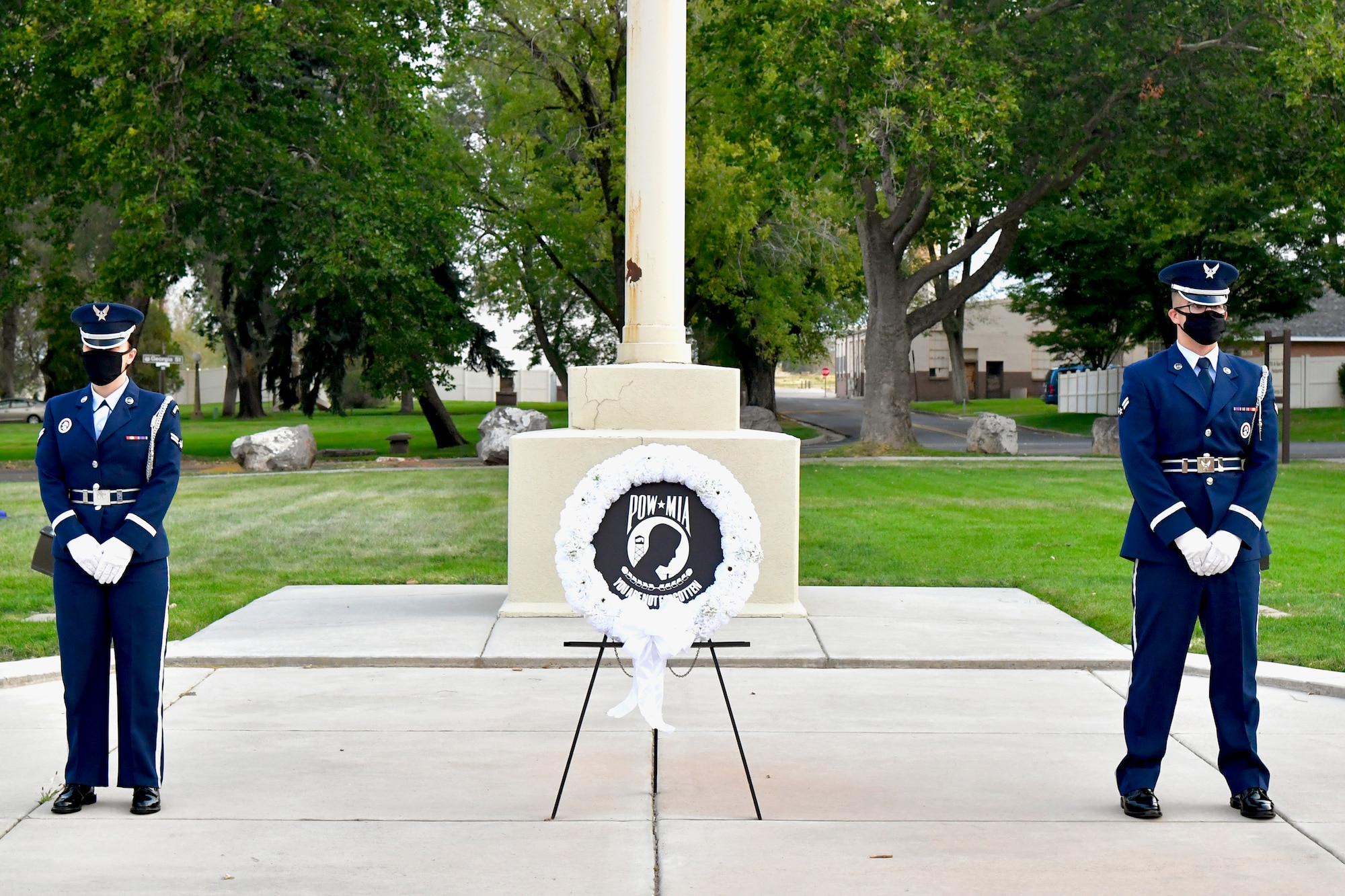 Two members of the Team Hill Honor Guard stand watch over a wreath during the POW/MIA commemoration ceremony.
