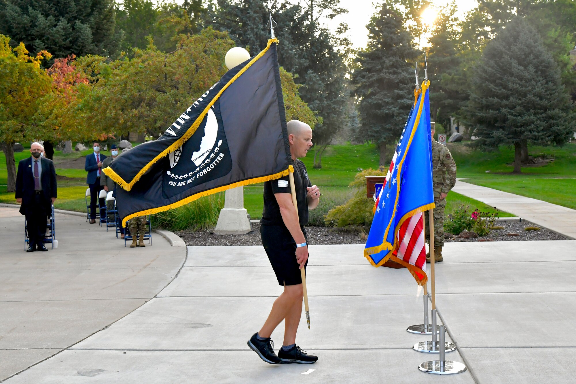 Chief Master Sgt. Christopher Walker, 75th Air Base Wing command chief, posts the POW/MIA flag during the POW/MIA commemoration ceremony.