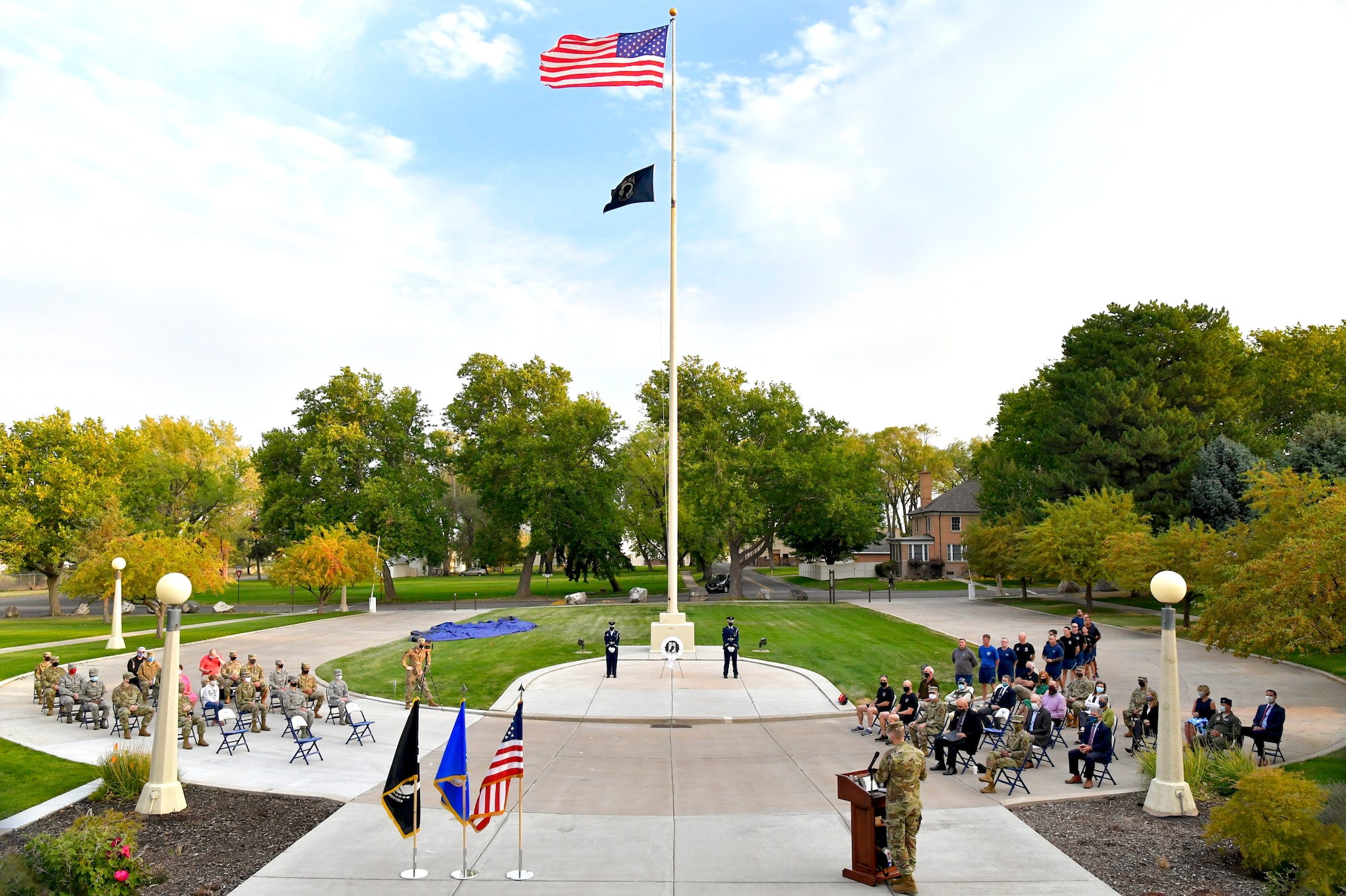 A wide-angle portrait of members of the military and community gathered to attend the POW/MIA commemoration ceremony.