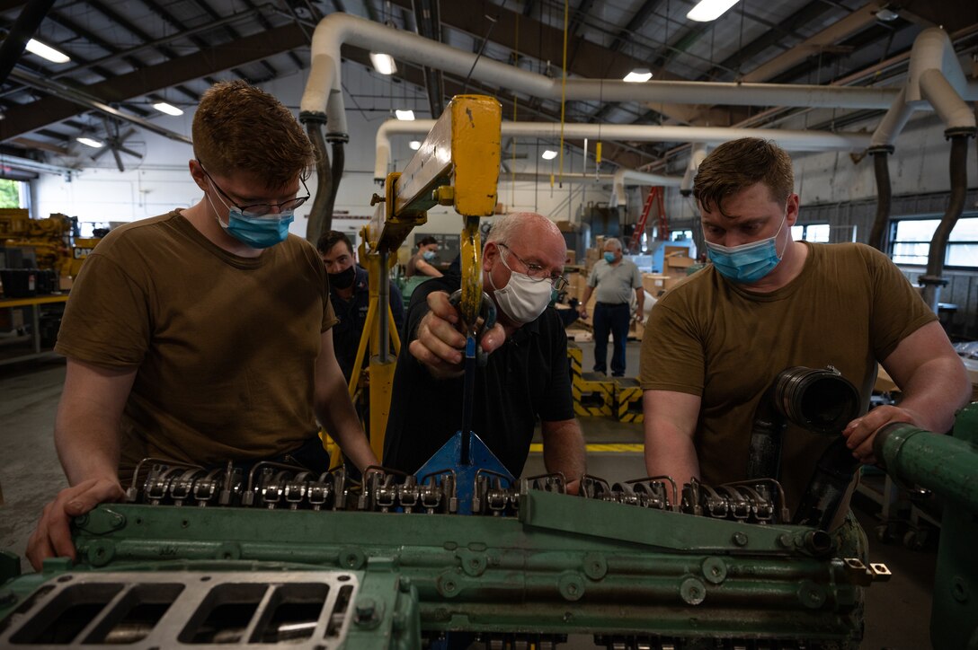 Sailors are shown how to put a Detroit Diesel 12D71 together at the Maritime & Intermodal Training Center.