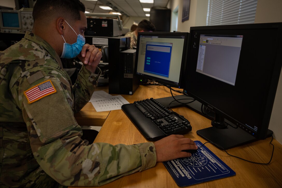 A Soldier does math problems on his first day of training at the Maritime & Intermodal Training Center at Fort Eustis.