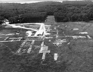 ‘Minitrack’ at Blossom Point — Developed by NRL to track the Vanguard satellite, Minitrack (Minimum Trackable Satellite) incorporated NRL's phase-comparison and angle-tracking techniques and utilized a series of fan-shaped vertical antenna beams forming a "fence." The antennas are seen as rectangular-shaped objects on the field. The system comprised a chain of stations extending from Blossom Point, Maryland, to Santiago, Chile, with additional stations at San Diego, California, Australia and South Africa. The data collected by these stations, telemetered from the Vanguard satellite, were transmitted to NRL's Control Center in Washington, D.C. The Blossom Point station was also used in NRL's demonstration to prove the feasibility of tracking non-radiating satellites, which led to NRL's development of the U.S. Naval Space Surveillance System (NAVSPASUR).