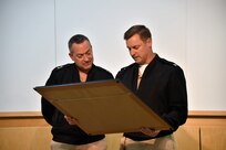Rear Adm. Mathias Winter, chief of naval research, receives a framed photograph of the U.S. Naval Research Laboratory from Capt. Mark Bruington, NRL commanding officer, during a scheduled visit. NRL provides the advanced scientific capabilities required to bolster our country's position of global naval leadership.