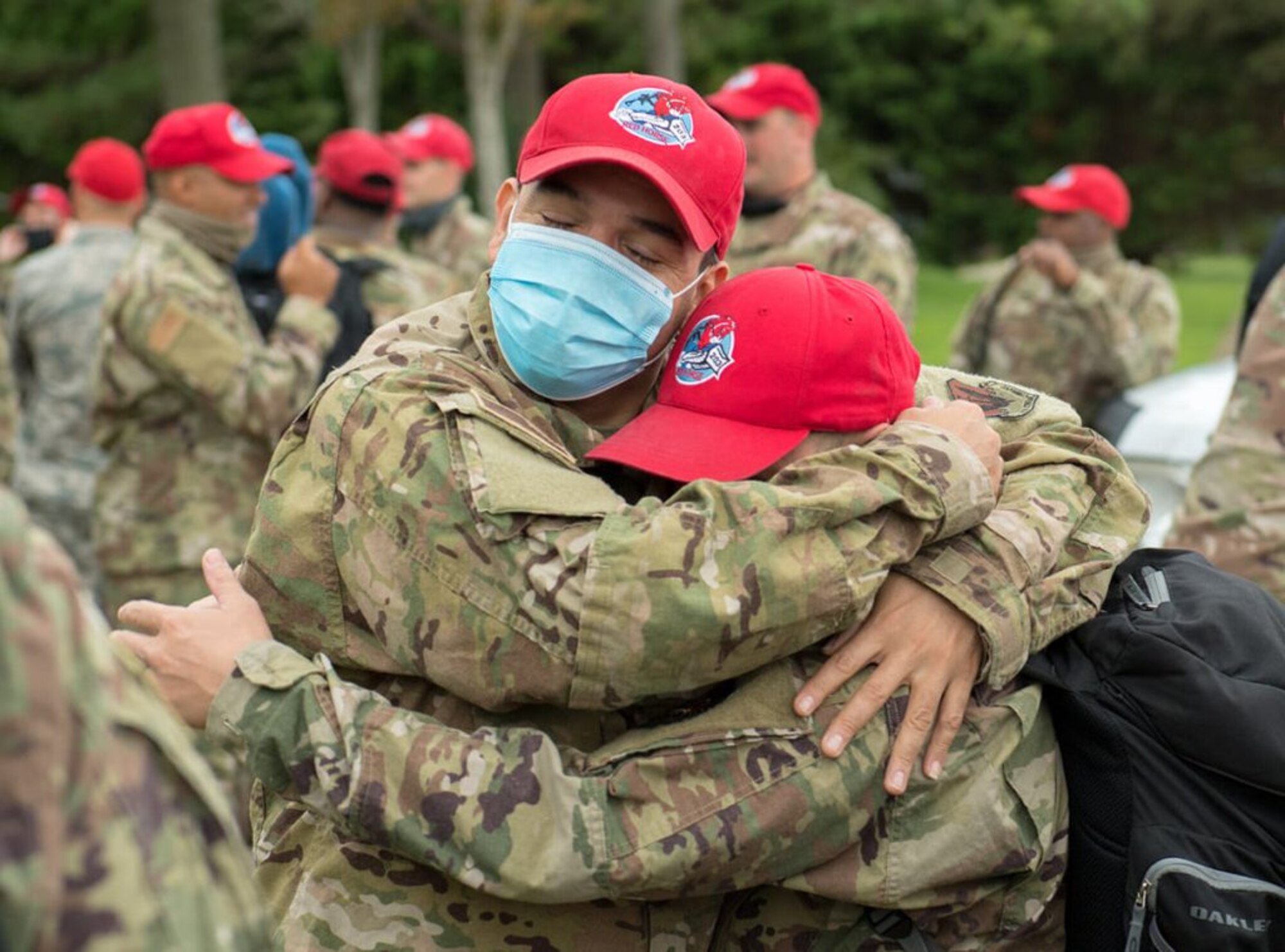Two airmen hug