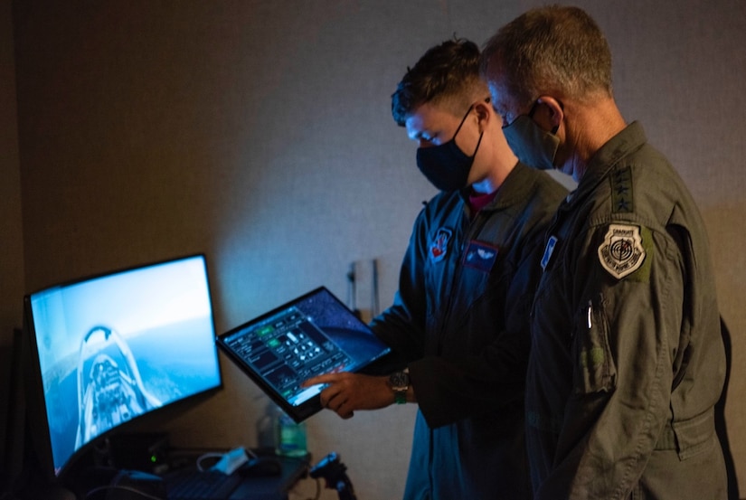 U.S. Air Force Gen. Mark Kelly, Air Combat Command commander, is briefed by an Airman.