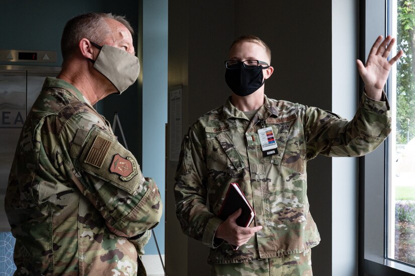 U.S. Air Force Gen. Mark Kelly, Commander of Air Combat Command, is briefed by an Airman.