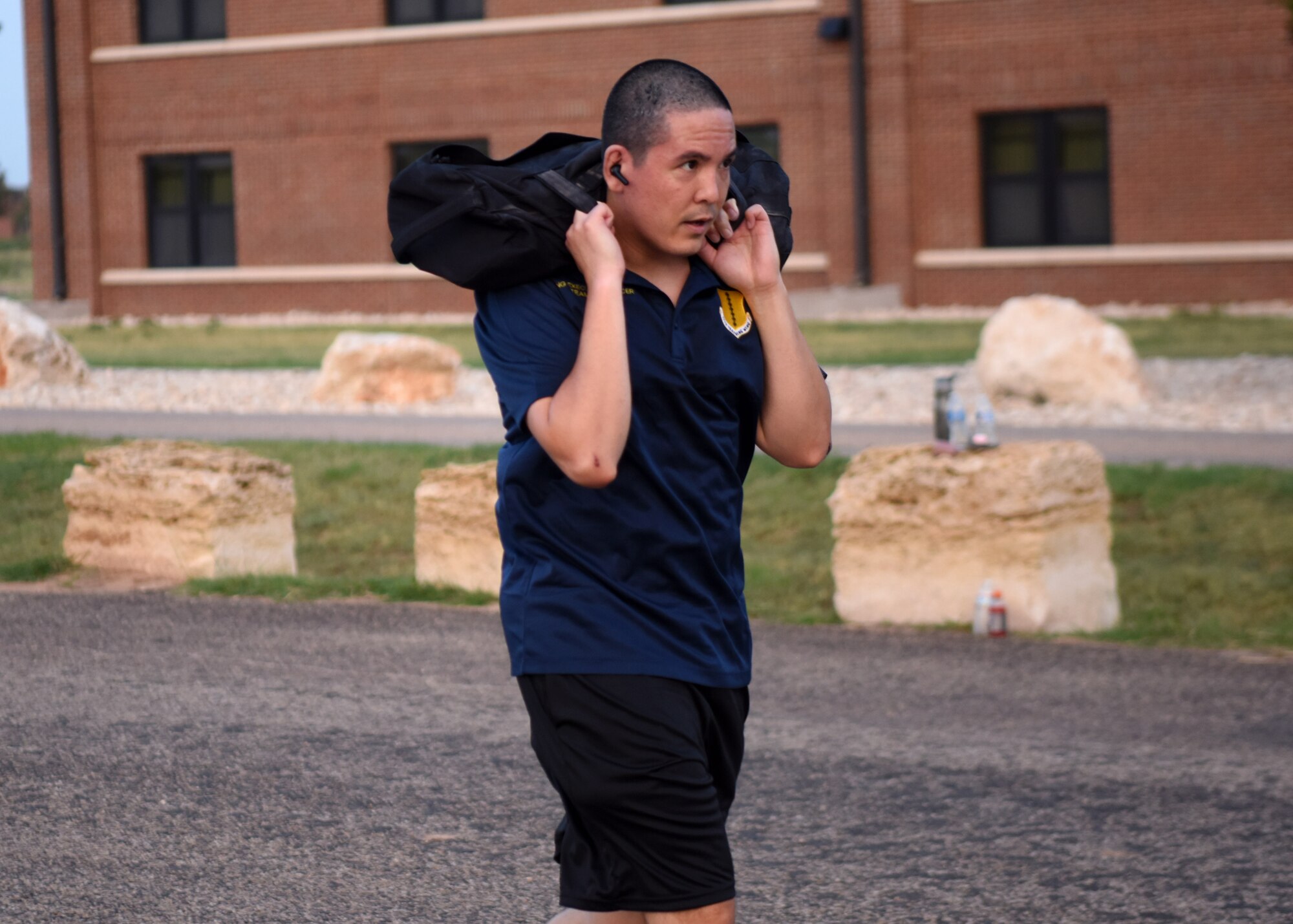 U.S. Air Force Capt. Ishmael, 17th Training Wing executive officer, rucks with weight on his shoulders during the Celebration of You run on Goodfellow Air Force Base, Texas, Sept. 17, 2020. Runners could walk, run, ruck, hop, or skip their way through the course to celebrate the Air Force’s 73rd Birthday. (U.S. Air Force photo by Airman 1st Class Ethan Sherwood)