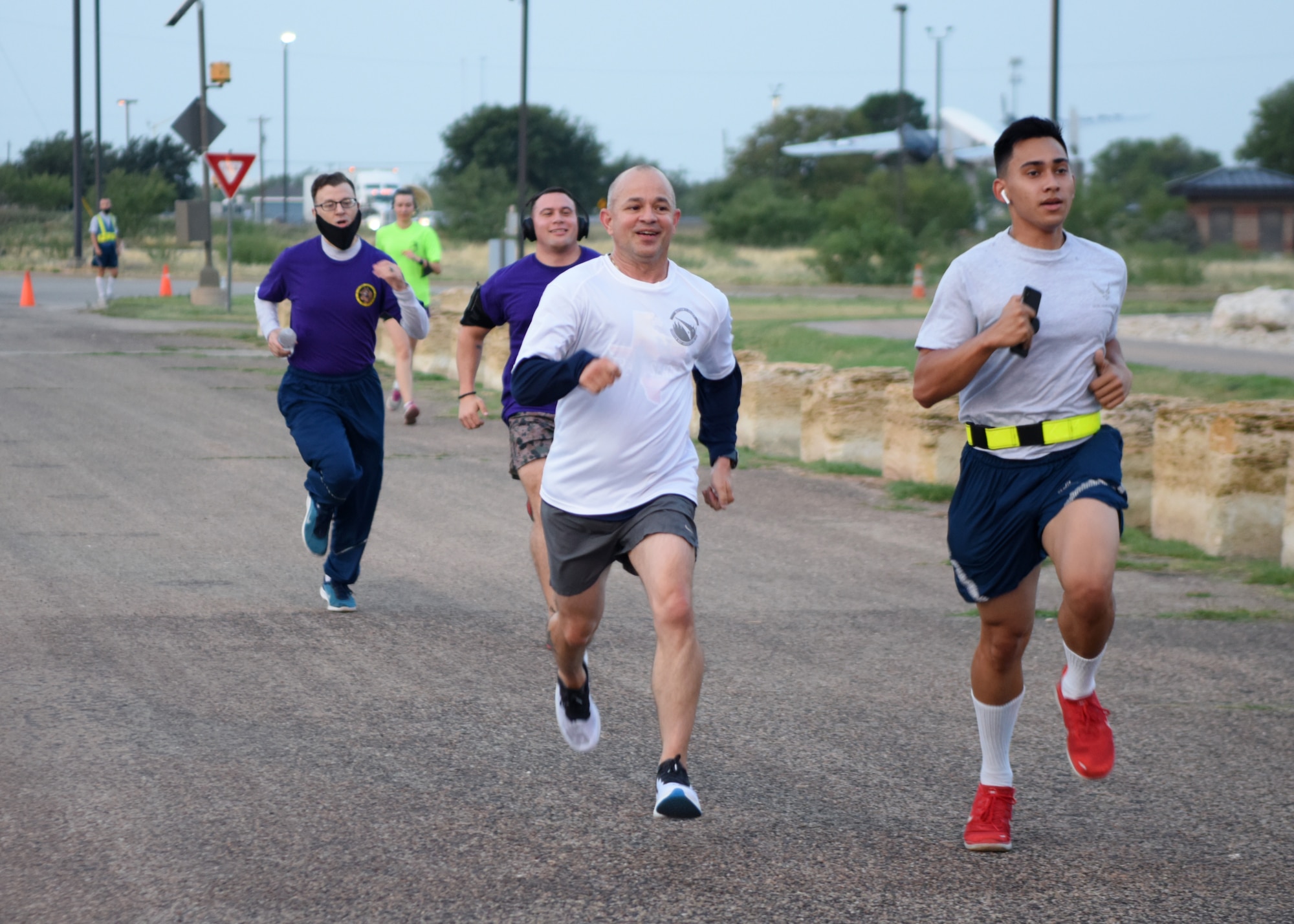 U.S. Air Force Col. Nazario, 17th Training Wing commander, races a student to the finish line during the Celebration of You run on Goodfellow Air Force Base, Texas, Sept. 17, 2020. Nazario returned after finishing to run with Airmen and encouraged them. (U.S. Air Force photo by Airman 1st Class Ethan Sherwood)
