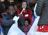A local student is all smiles as he receives his Santa-sized bag full of gifts at NRL’s 50th children’s holiday party Dec. 12, 2016.