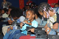 Local school children enjoyed snacks and entertainment, sang Christmas carols and visited with Santa Claus and Ronald McDonald during a day-long children’s holiday party Dec. 12, 2016. NRL celebrated the party’s 50th anniversary this year