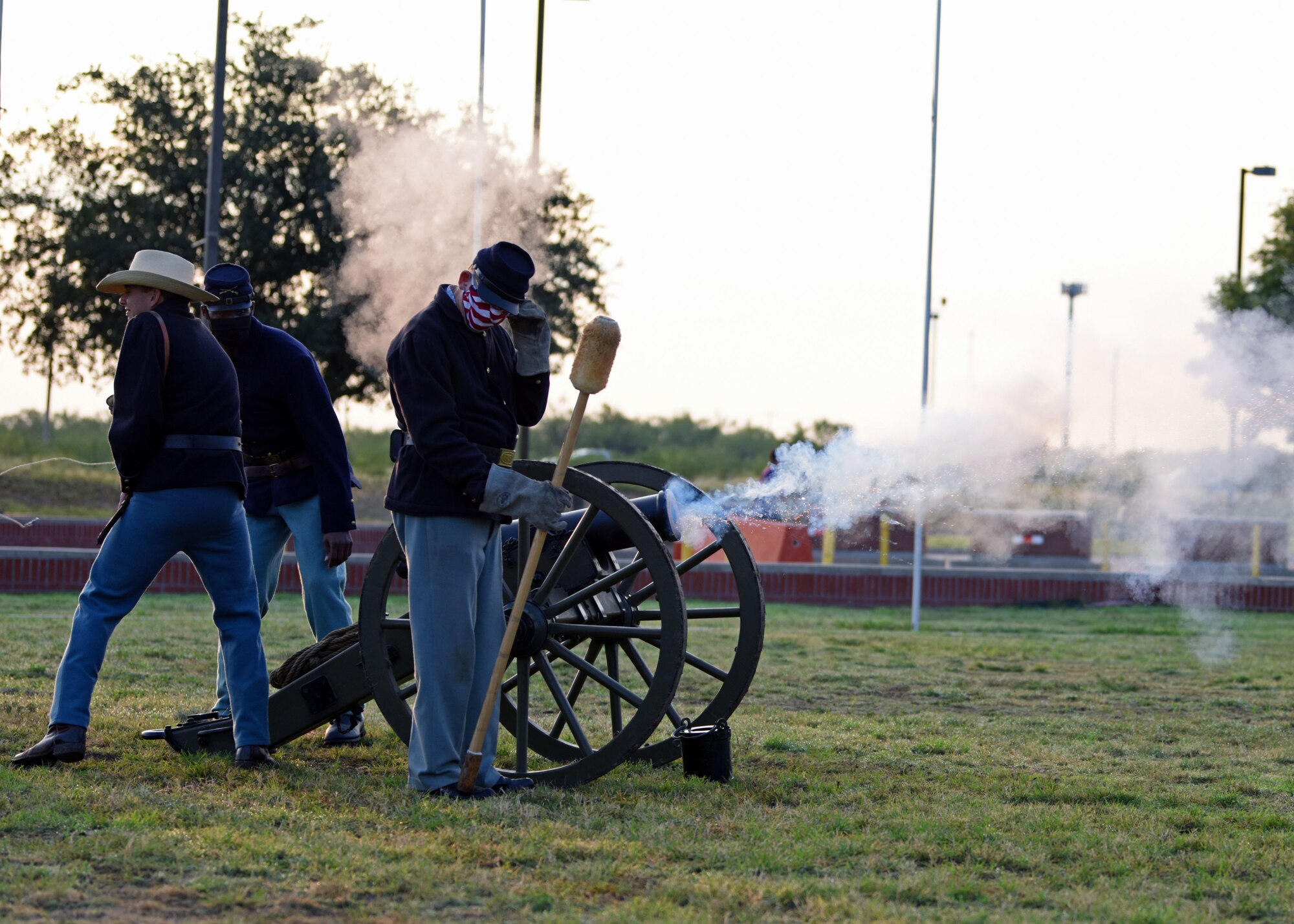 Fort Concho National Historic Landmark re-enactors and Buffalo Soldier volunteer fire a howitzer during the Air Force Birthday Celebration on the Parade Field at Goodfellow Air Force Base, Texas, Sept. 18, 2020. The re-enactors and volunteers helped to demonstrate the role of the Buffalo Soldier’s in supporting the westward expansion of the nation. (U.S. Air Force photo by Airman 1st Class Ethan Sherwood)