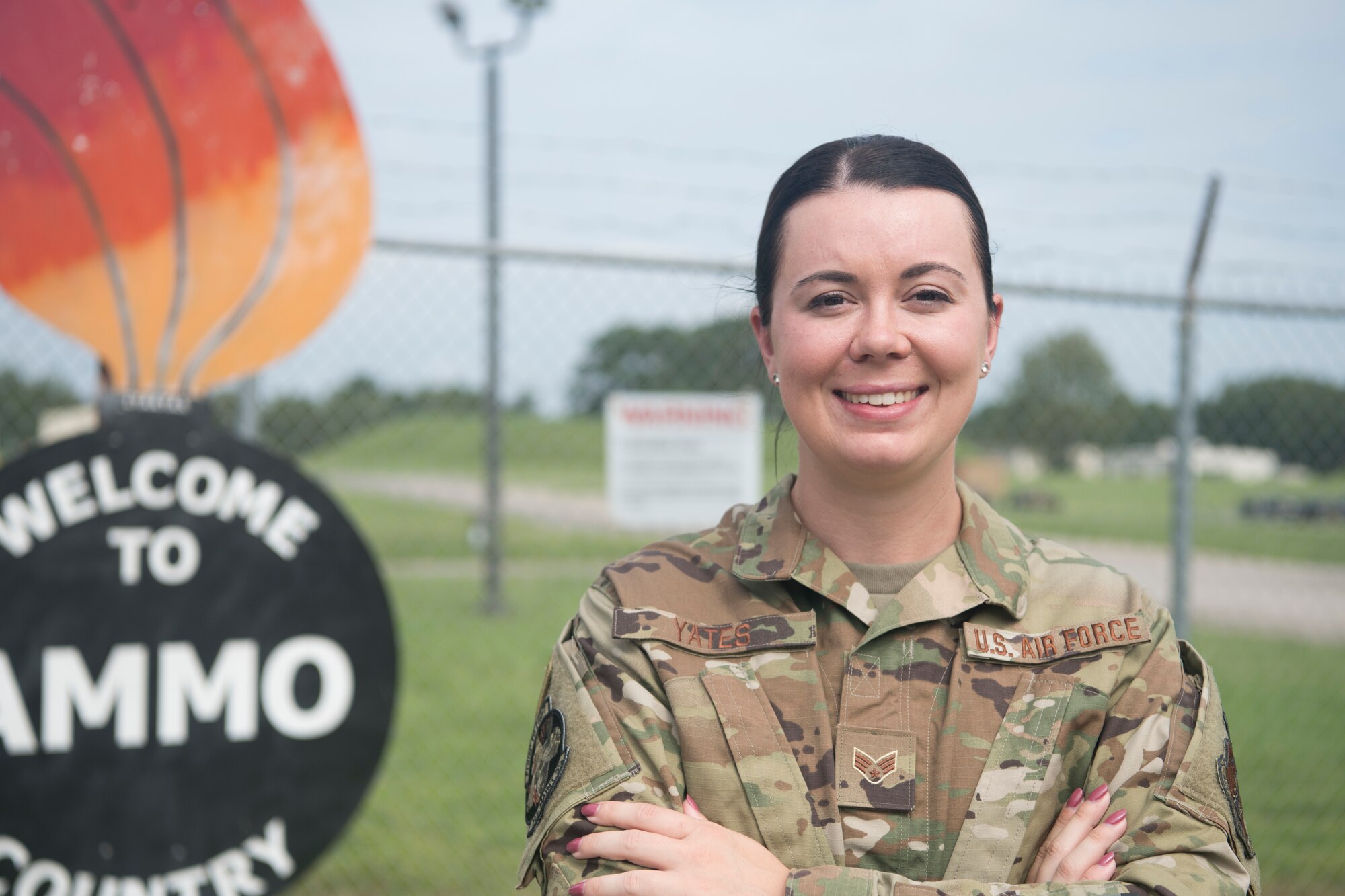 A female Airman poses for a photo