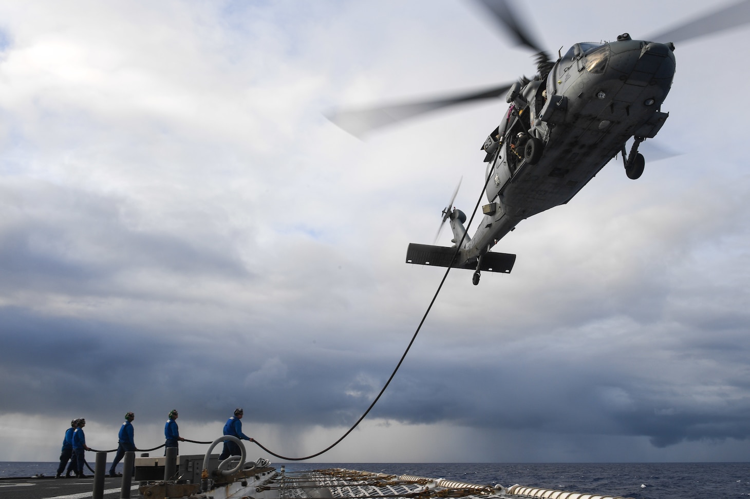 U.S. Coast Guardsmen assigned to the Legend-class cutter USCGC Munro (WMSL 755) conduct a helicopter in-flight refuel (HIFR) with an HM-60S Sea Hawk Helicopter assigned to Helicopter Sea Combat Squadron (HSC) 21, August 18.